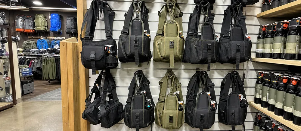Wilderness outfitter retail store stocking bear spray chest holsters as a core SKU alongside bear spray canisters