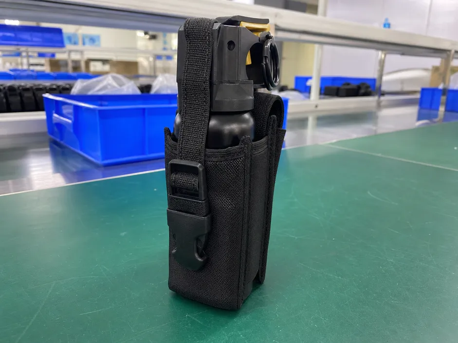 Bear spray canister seated in hiking holster showing engineered retention fit — 50–65mm diameter, 150–200mm height