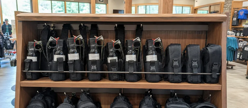 National park visitor center retail display with bear spray and holster bundle for day hikers