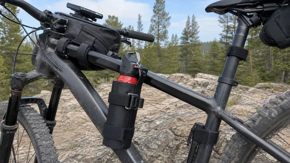 SOHAPI bear spray frame mount holster — strap-and-buckle system for top tube, down tube, or fork leg mounting