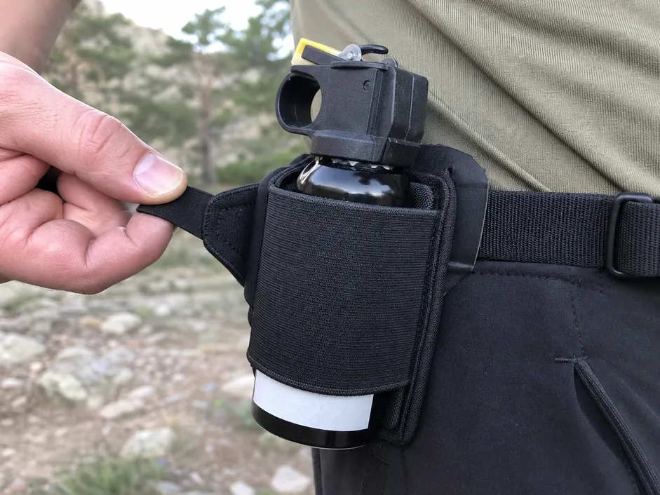 Close-up of elastic retention band and pull-tab release mechanism on SOHAPI bear spray running holster