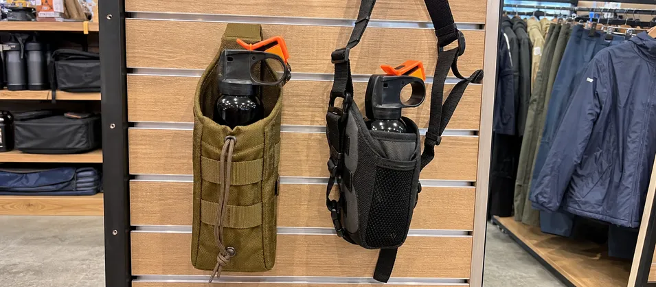 Outdoor specialty retailer with both hiking and trail running bear spray holster SKUs displayed side by side