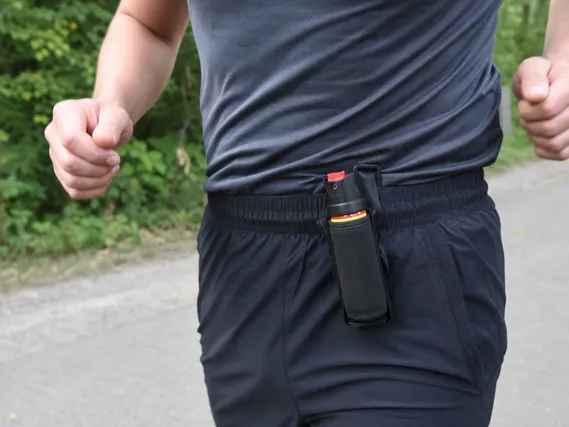 Bear spray running holster clipped to athletic waistband