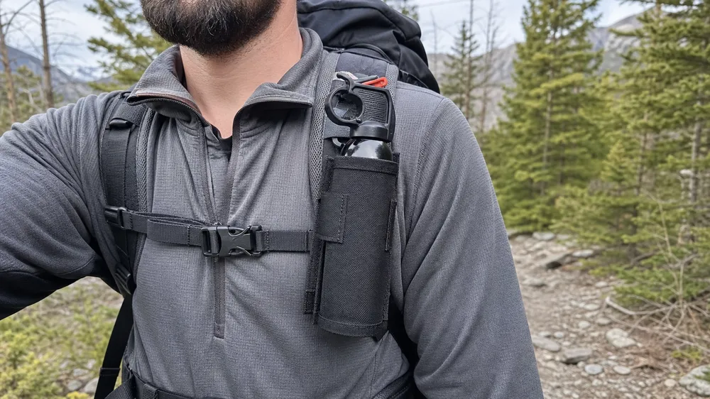 Bear spray hiking holster attached to backpack shoulder strap — compatible with wide range of pack systems