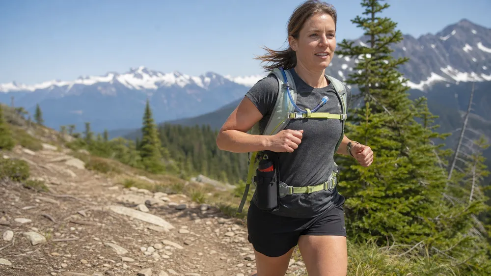 Bear spray running holster on trail runner — purpose-built for fast-packing and trail running segment