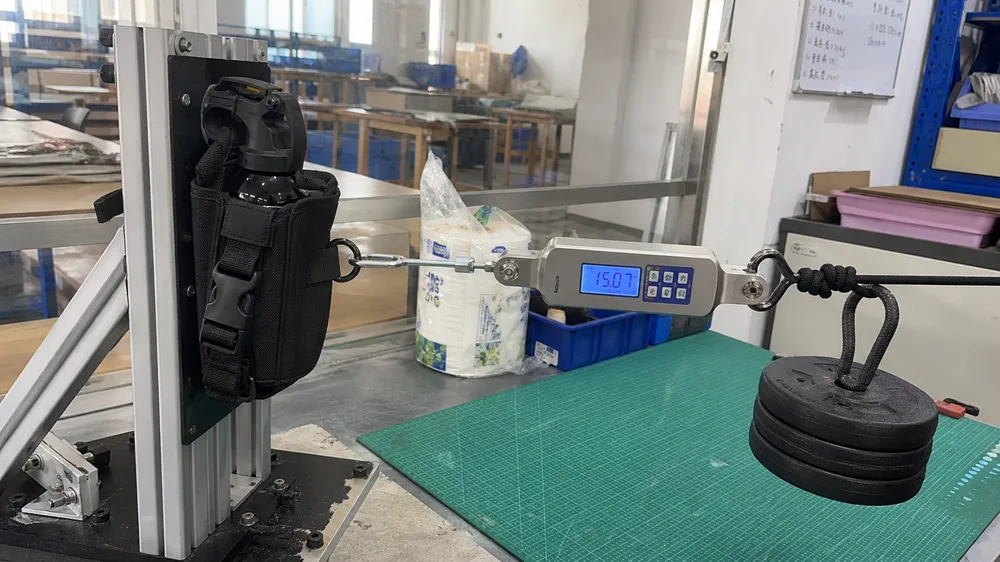 Bear spray holster retention force testing under simulated lateral load conditions