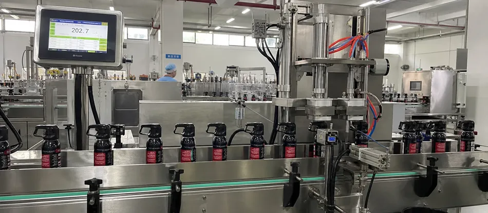 Gravimetric fill control station on aerosol production line with real-time weight monitoring