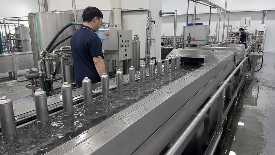 Automated water bath leak test line for aerosol canister quality control