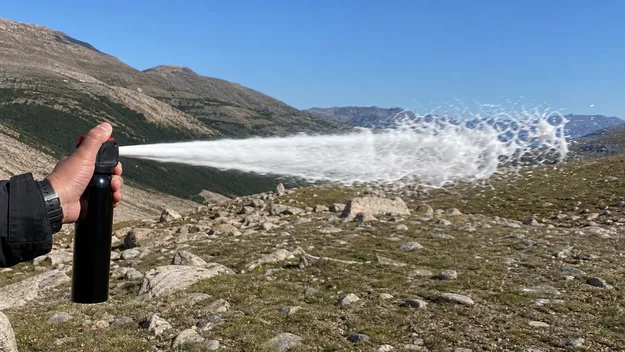 Bear spray foam deployed in open alpine terrain with high crosswind conditions