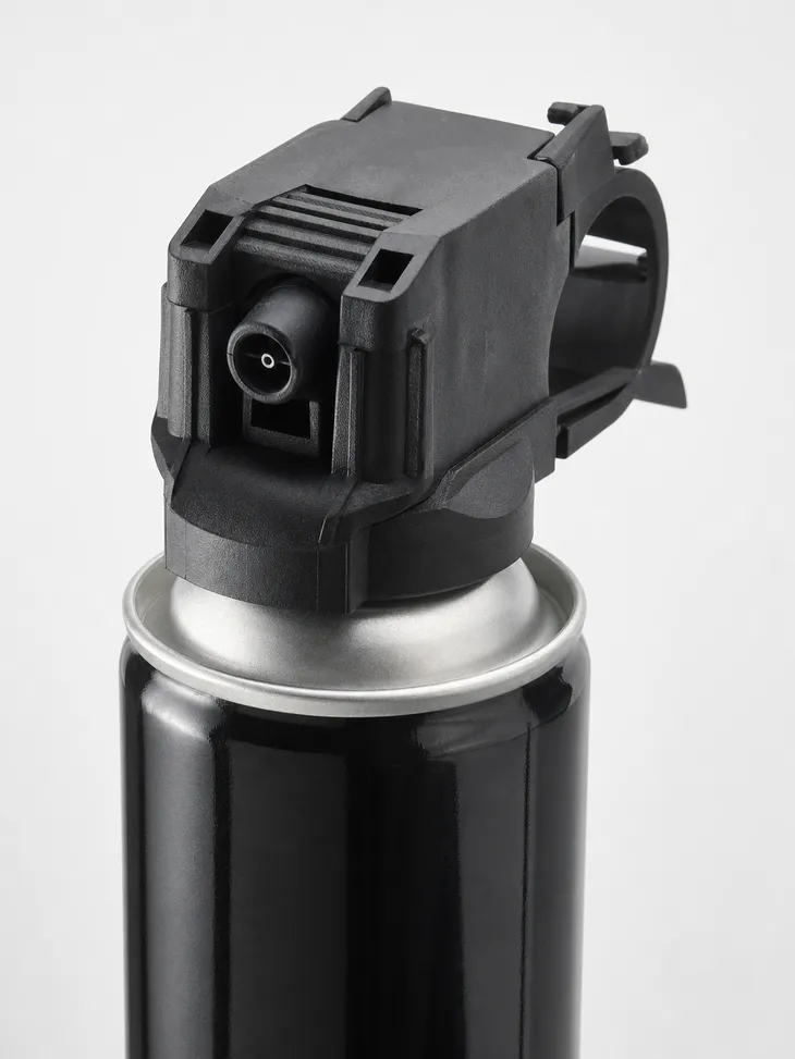 Max Bear Attack Bear Spray canister detail — 13.4 oz tinplate steel with wide-cone actuator