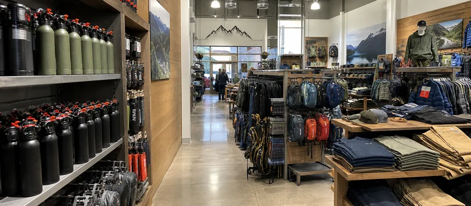 Premium outdoor retail store in national park gateway town stocking bear spray