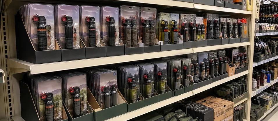 Outdoor retail and sporting goods store shelves stocked with bear spray