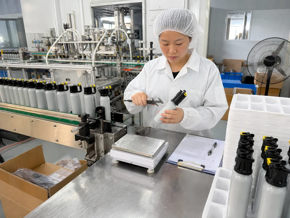 Quality control inspection of training bear spray canisters on the production floor