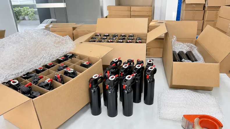 Training bear spray canisters prepared for standard air freight shipment — no dangerous goods documentation required